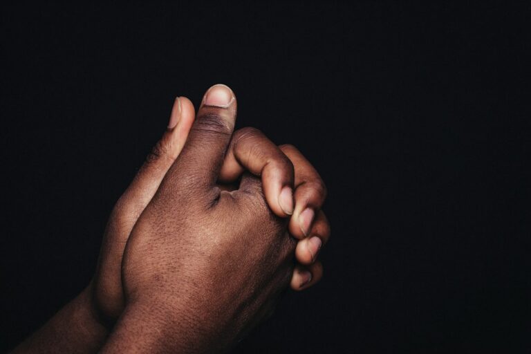 Two hands clasped together