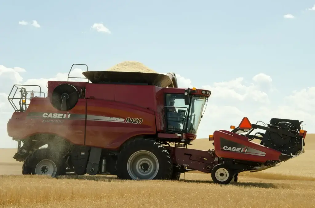 Combine harvesting a field of wheat