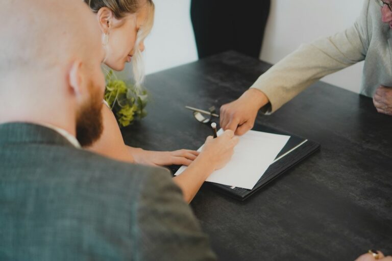 Couple signing documents with an attorney