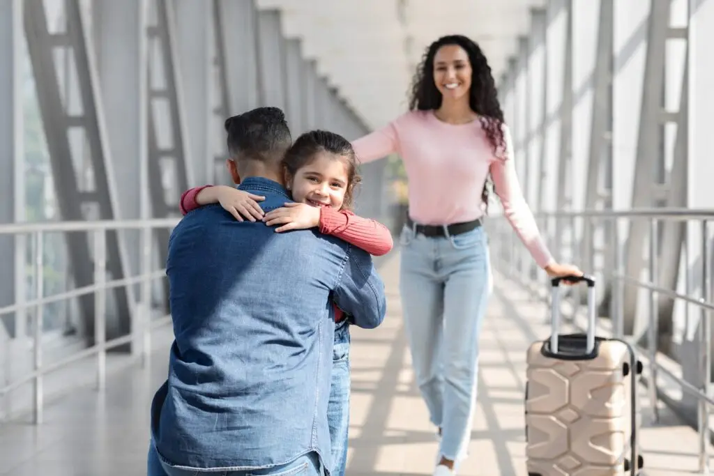 Family reuniting with a hug at the airport