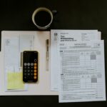 Tax forms, calculator and coffee on a desk